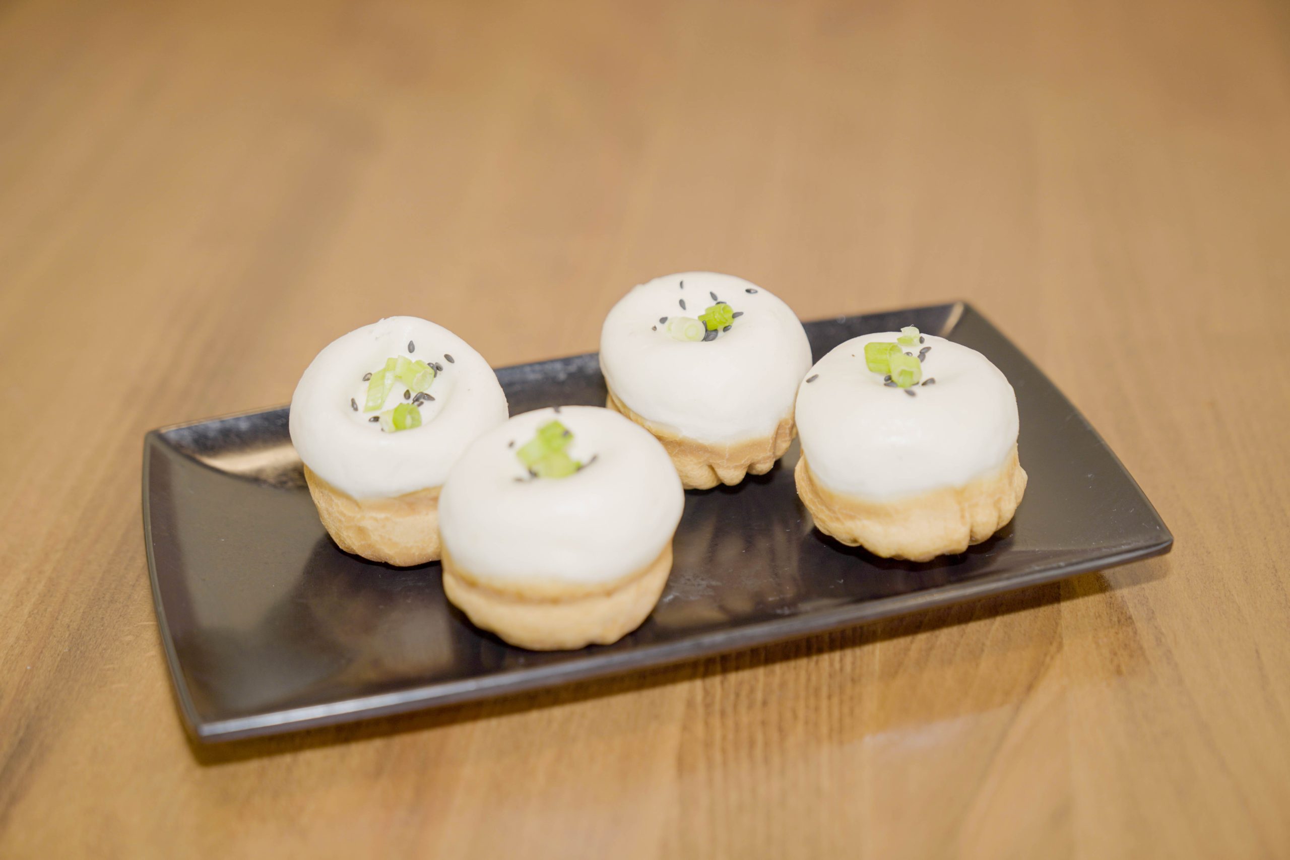 Pan - fried buns with white topping, scallions, and sesame seeds at Dao Artisan Noodle, a Chinese Restaurant in San Leandro