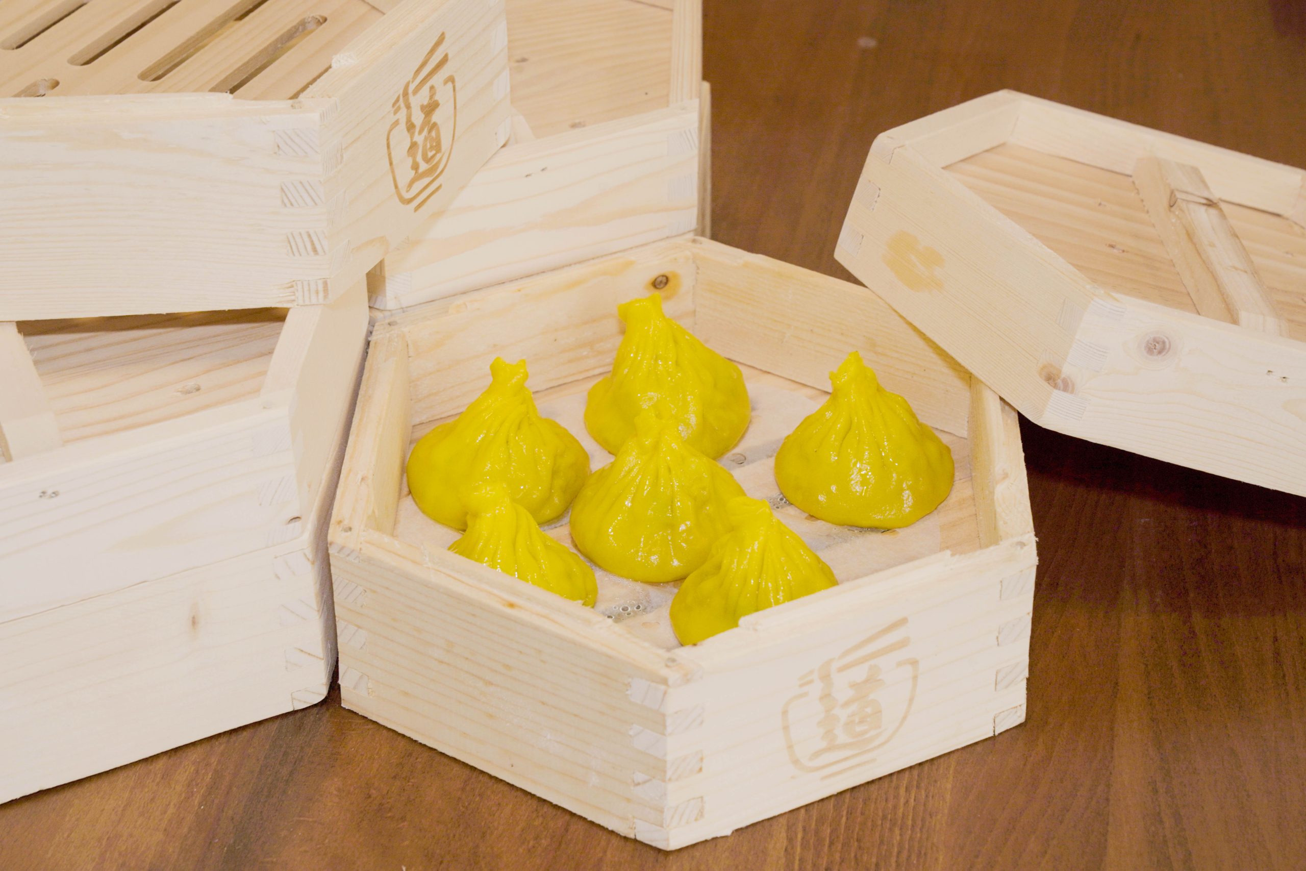 Yellow sour soup xiaolongbao in wooden steamer at Dao Artisan Noodle, a Chinese Restaurant in San Leandro