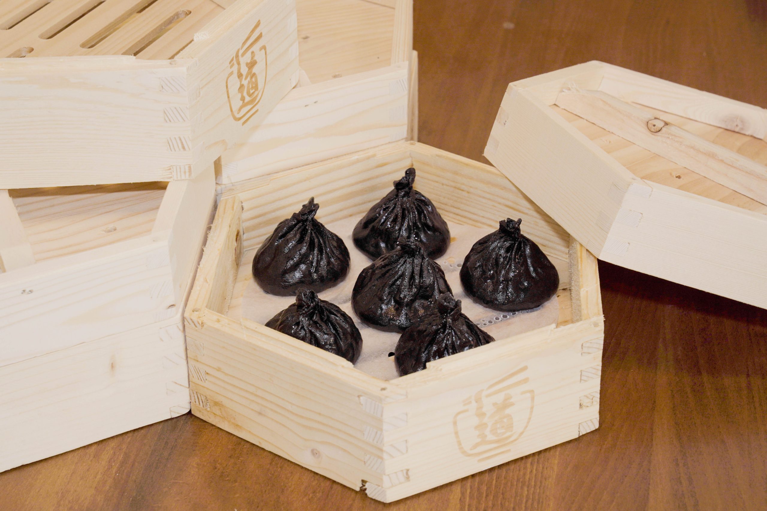 Delicate black truffle xiaolongbao in wooden steamer at Dao Artisan Noodle, a Chinese Restaurant in San Leandro