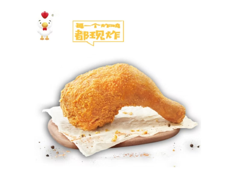 Crispy fried chicken leg on parchment paper with cartoon chicken logo at Delicious Fried, a Fast‑food Restaurant in Los Angeles