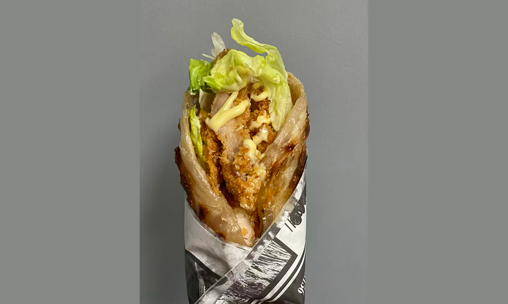 Crispy chicken wrap with lettuce and creamy sauce, a tasty handheld option at Devils Kitchen & Teppan, a Asian Restaurant in Eastvale