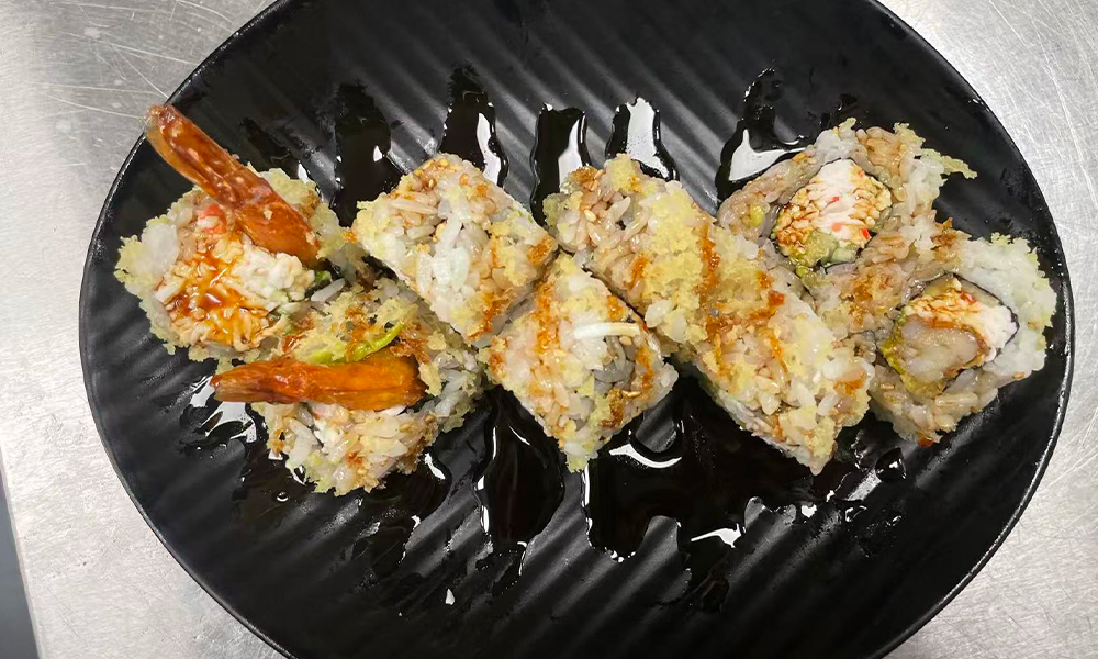 Shrimp tempura roll with crunchy topping and sauce, a tasty sushi option at Devils Kitchen & Teppan, a Asian Restaurant in Eastvale