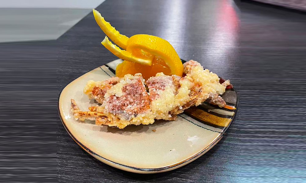 Soft-shell crab tempura with lemon garnish, a crispy seafood appetizer at Devils Kitchen & Teppan, a Asian Restaurant in Eastvale