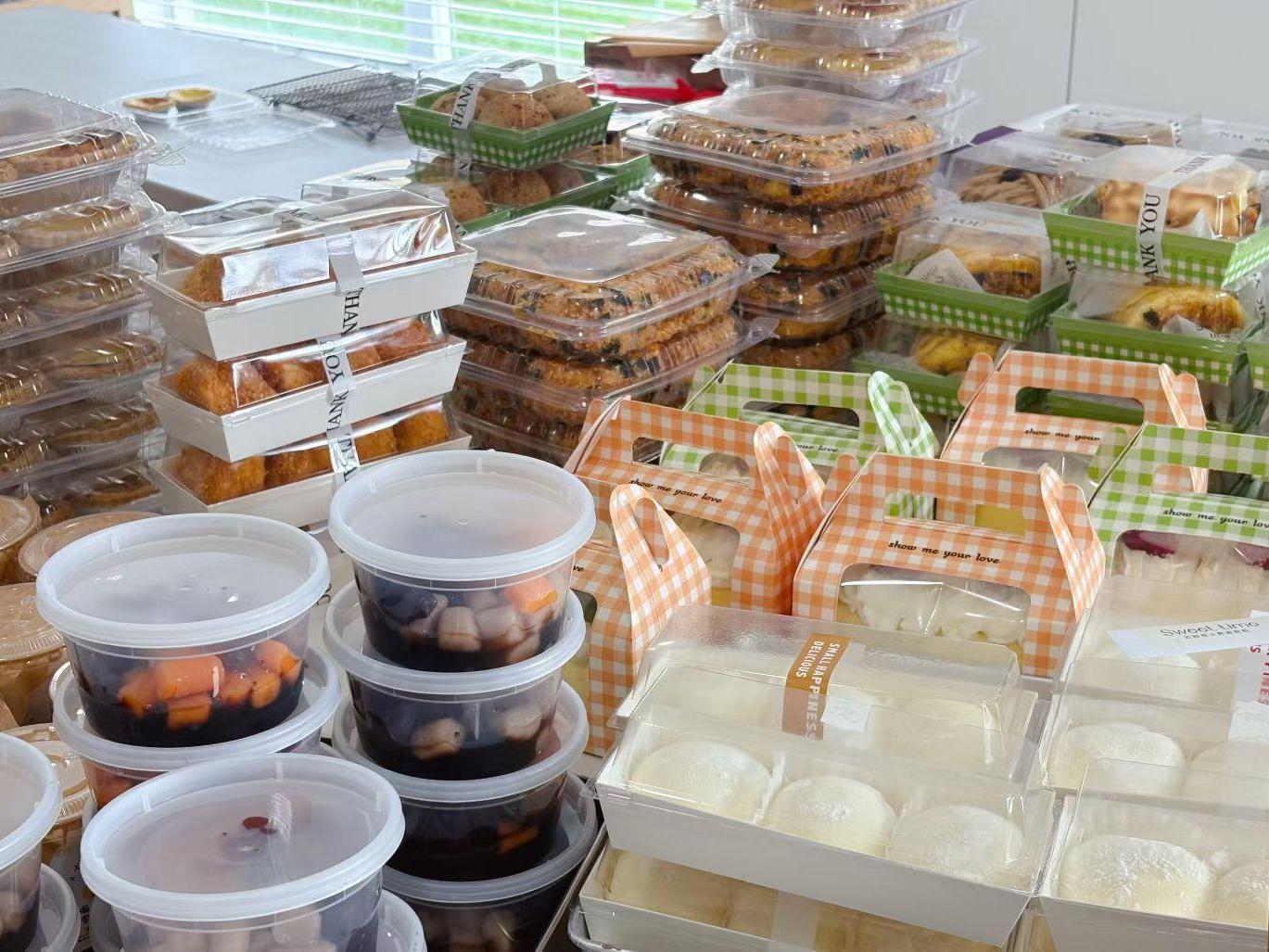 Assorted desserts including pastries, buns & sweet soup in containers at D For Dessert, a Coffee & Cake Shop in Hollywood