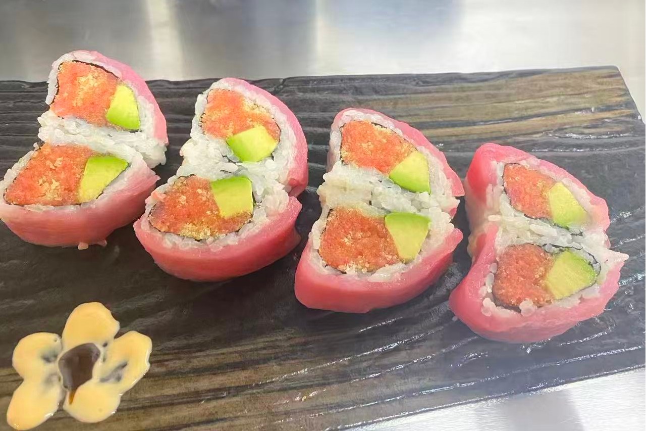 Dharma-Sushi&Grill-Japanese-Restaurant-Pink-Wrapped-Sushi-Roll-Schenectady Sushi rolls wrapped in pink - colored material with avocado and fish filling at Dharma Sushi & Grill, a Japanese Restaurant in Schenectady