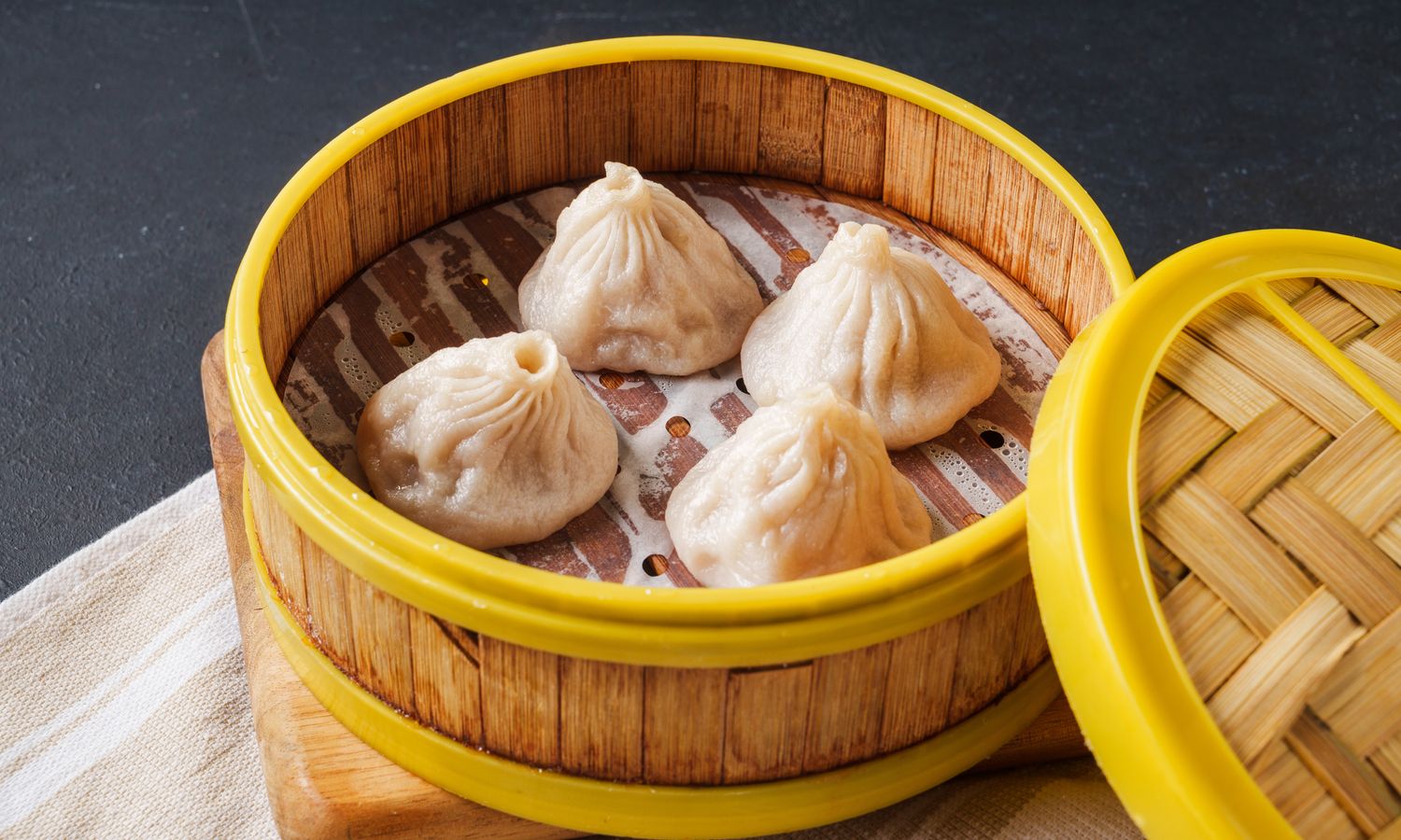 Juicy pork dumplings with savory broth at Dim Sum Bloom Rockville Centre, a Chinese Restaurant in Rockville Centre