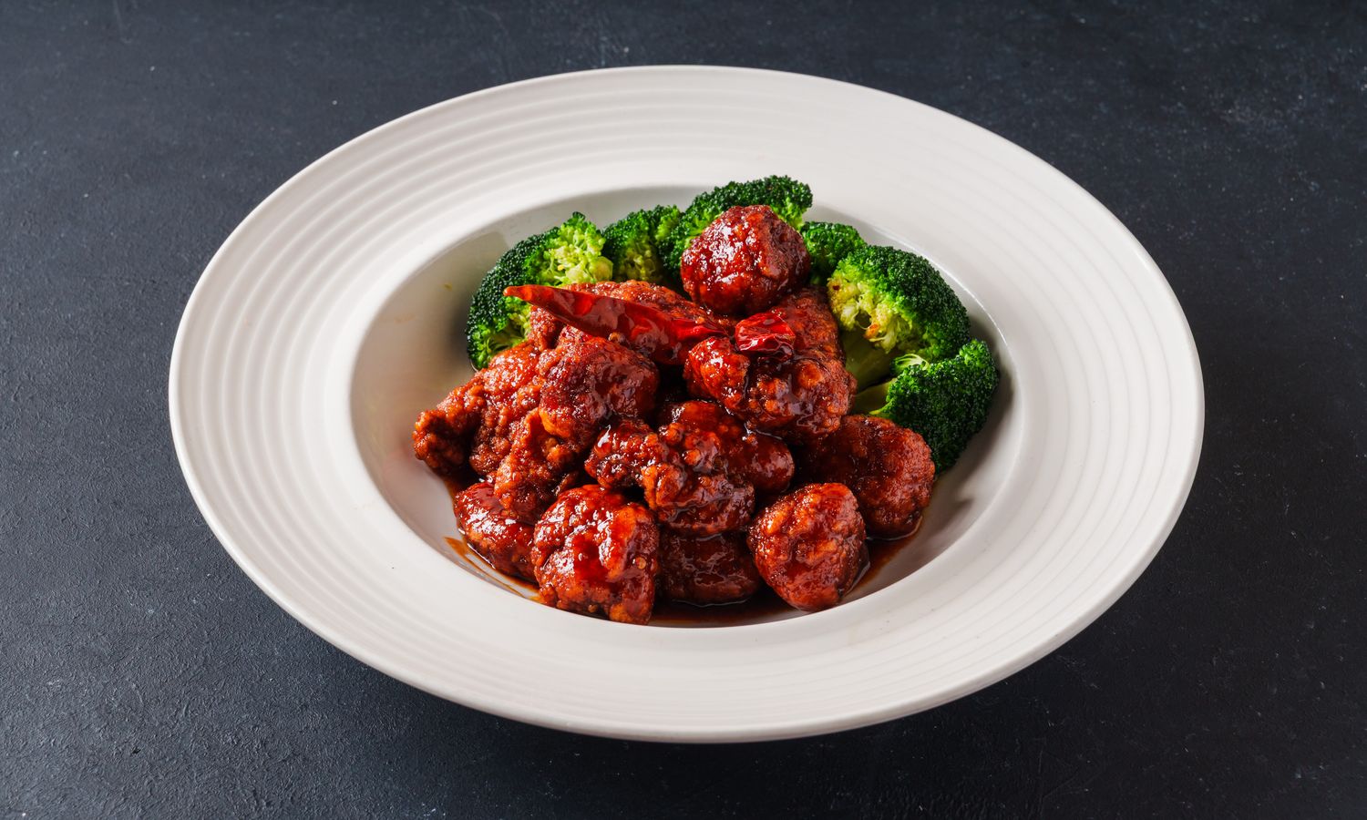 Crispy chicken in sweet and spicy sauce with broccoli at Dim Sum Bloom Rockville Centre, a Chinese Restaurant in Rockville Centre