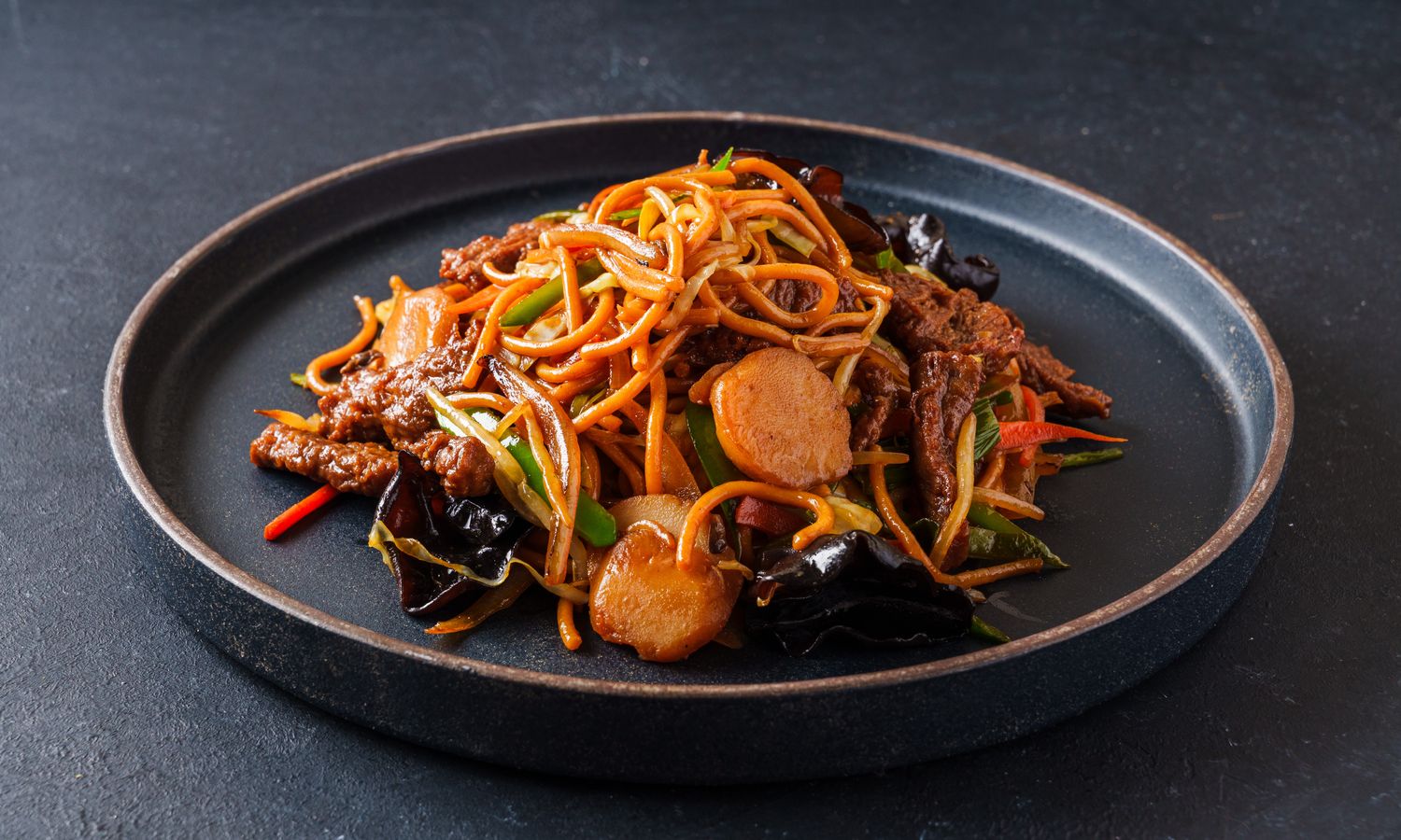 Chewy noodles stir-fried with meat and vegetables at Dim Sum Bloom Rockville Centre, a Chinese Restaurant in Rockville Centre