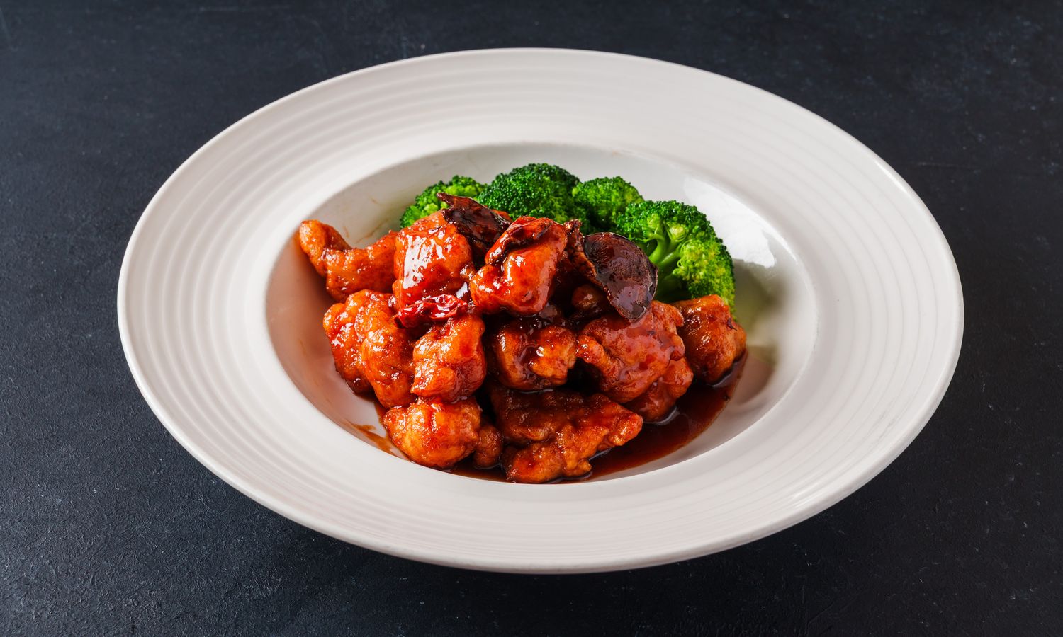 Crispy chicken in tangerine peel sauce with broccoli at Dim Sum Bloom Rockville Centre, a Chinese Restaurant in Rockville Centre