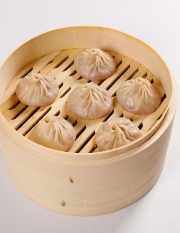 Plain pork soup dumplings served in bamboo steamer at Tom's Dim Sum, a Dim Sum Restaurant in PA