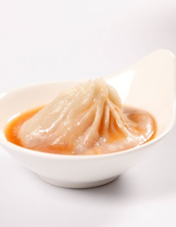 Single soup dumpling soaked in rich savory broth at Tom's Dim Sum, a Dim Sum Restaurant in PA