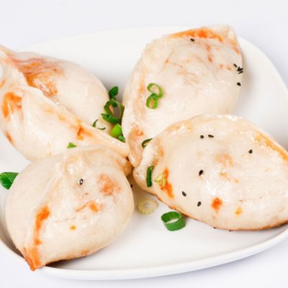 Steamed pork dumplings garnished with green onion at Tom's Dim Sum, a Dim Sum Restaurant in PA