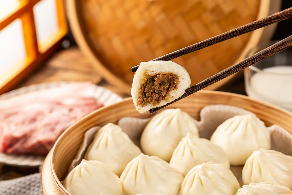 Steamed pork soup dumplings in bamboo steamer at Tom's Dim Sum, a Dim Sum Restaurant in PA