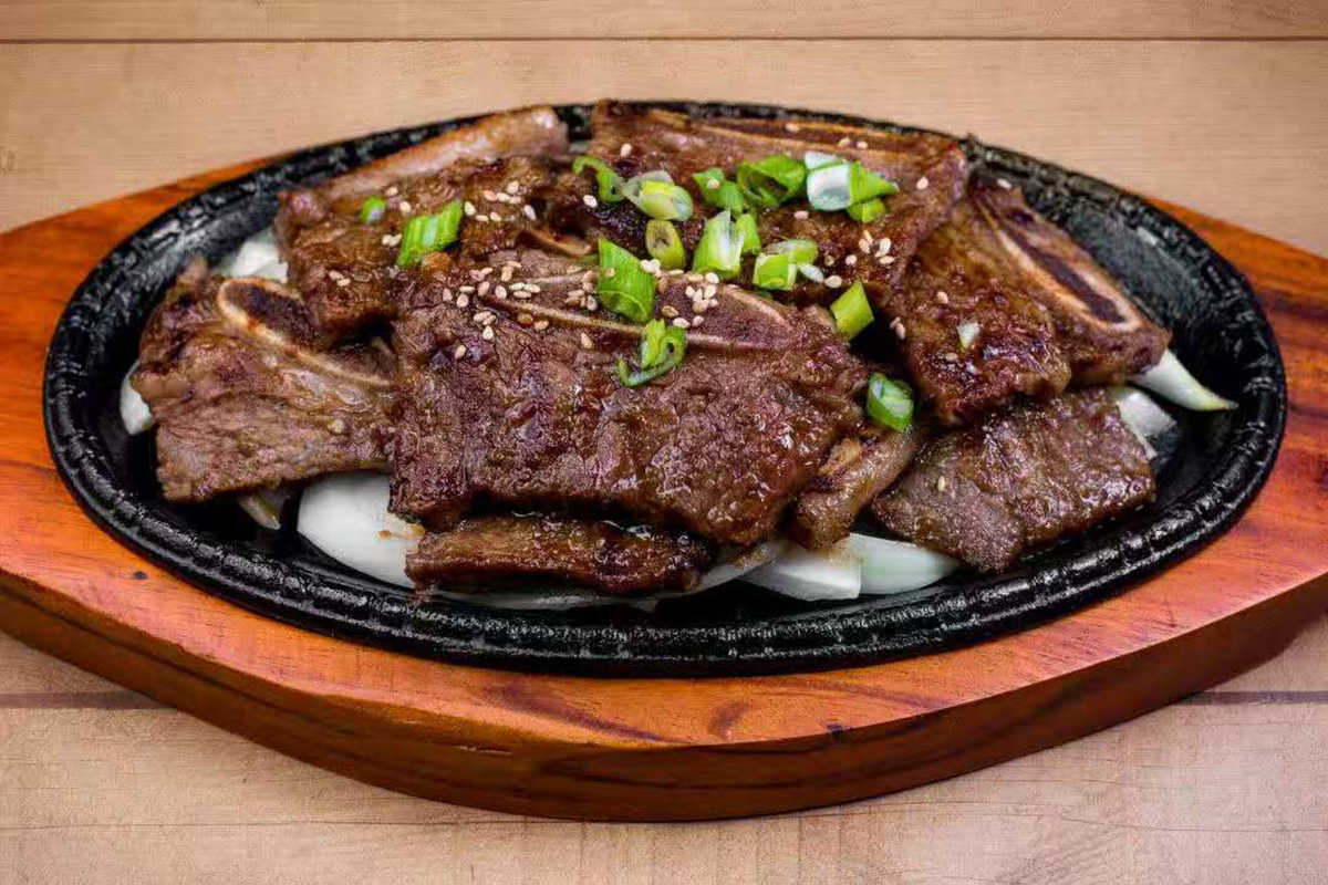 Marinated traditional cut of beef short rib in house special sauce at Dim Sum & Kimchi，a Asian Fusion Restaurant in Bettendorf