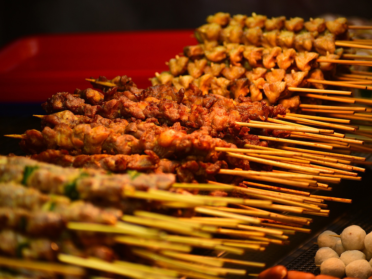 Assorted grilled meat skewers with spices, ready for serving at Ditan Er BBQ, a Barbecue restaurant in Flushing