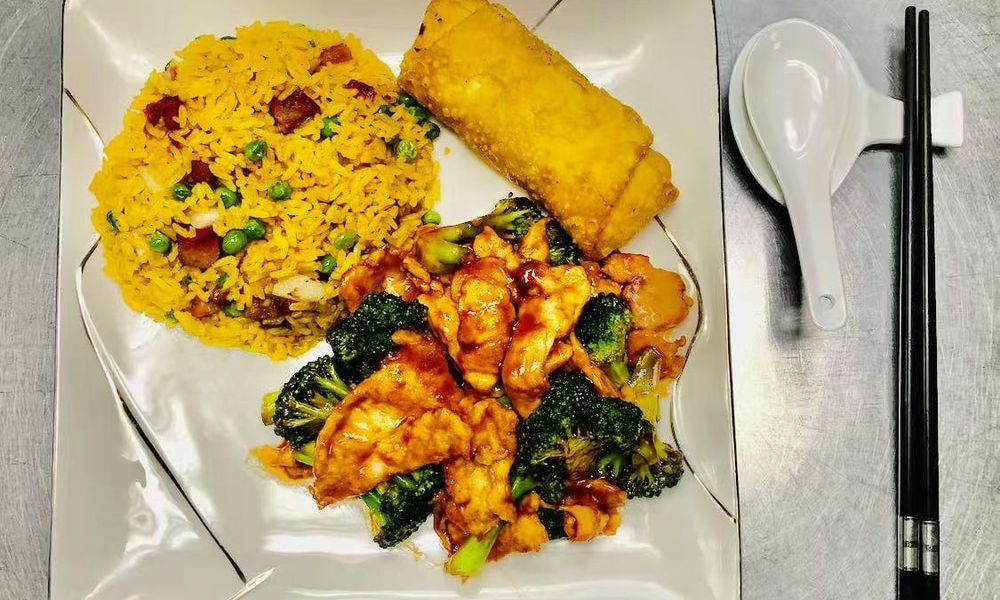 Fried Rice and Egg Roll Yellow fried rice with peas and ham, egg roll, chicken and broccoli stir-fry at Double Delight, a Chinese Restaurant restaurant in Brooklyn