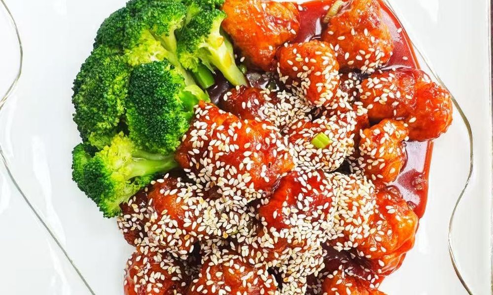 Sweet and Sour Chicken Succulent chicken pieces in a sweet and sour sauce, garnished with sesame seeds at Double Delight, a Chinese Restaurant restaurant in Brooklyn