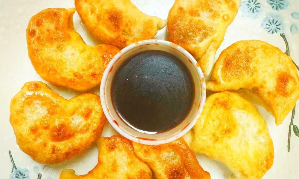 Potstickers Golden-brown fried dumplings with dipping sauce at Double Delight, a Chinese Restaurant restaurant in Brooklyn Potstickers Golden-brown fried dumplings with dipping sauce at Double Delight, a Chinese Restaurant restaurant in Brooklyn