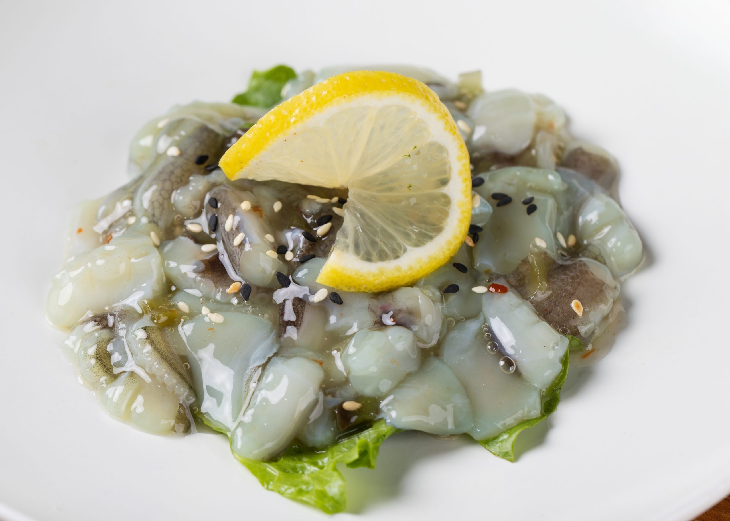 Fresh squid sashimi with sesame and lemon at Dozo Sushi & Bar, a Japanese Restaurant in Monrovia