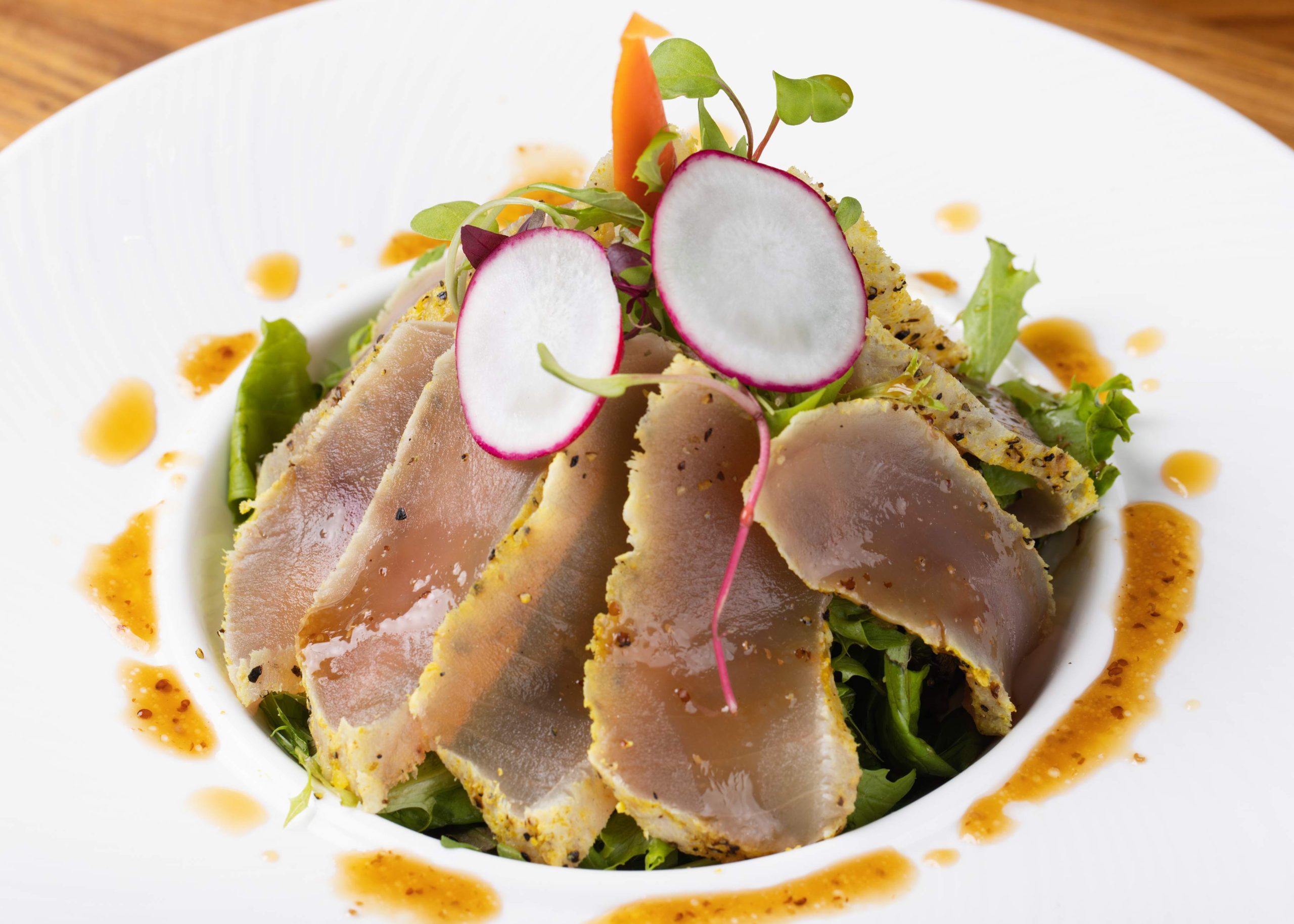 Sesame-crusted tuna over salad with dressing at Dozo Sushi & Bar, a Japanese Restaurant in Monrovia