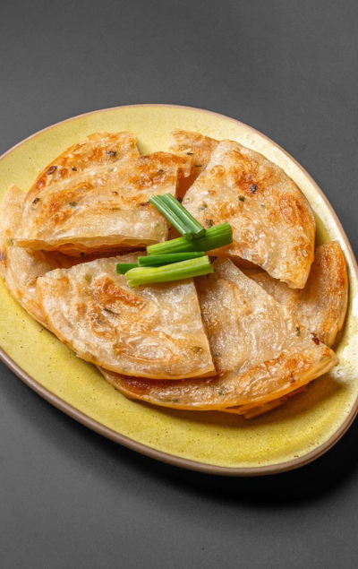 Golden scallion pancakes on a plate at Dragon 109 of Columbus, a Chinese Restaurant in New York