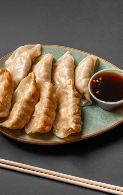 Steamed and fried dumplings with soy sauce at Dragon 109 of Columbus, a Chinese Restaurant in New York
