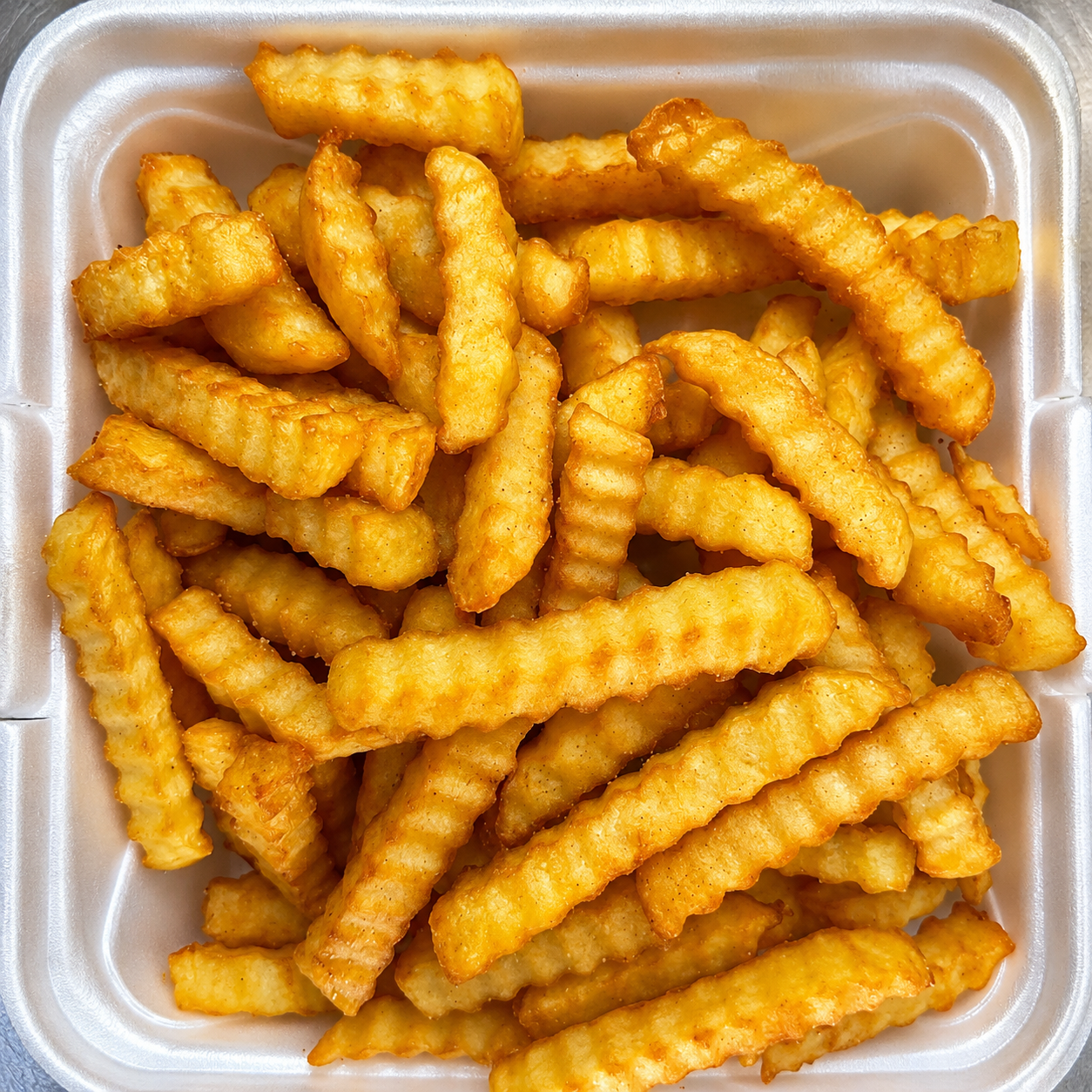 Golden crinkle-cut French fries at Dragon Express, a Chinese Restaurant in Augusta