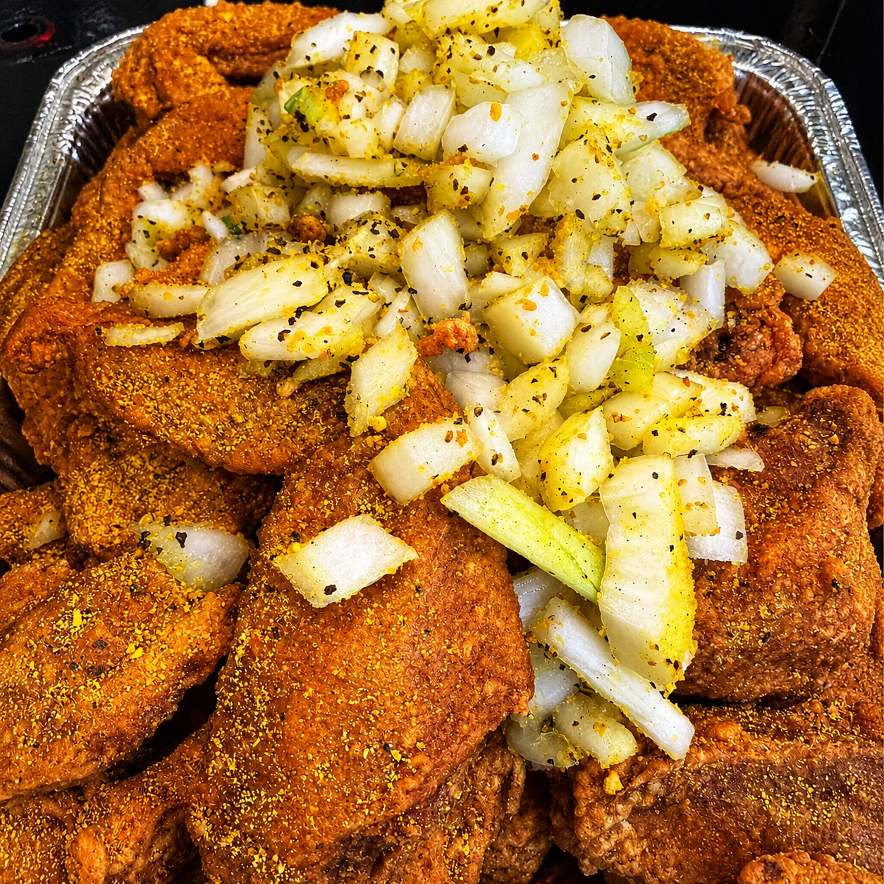 Fried chicken wings topped with onions at Dragon Express, a Chinese Restaurant in Augusta
