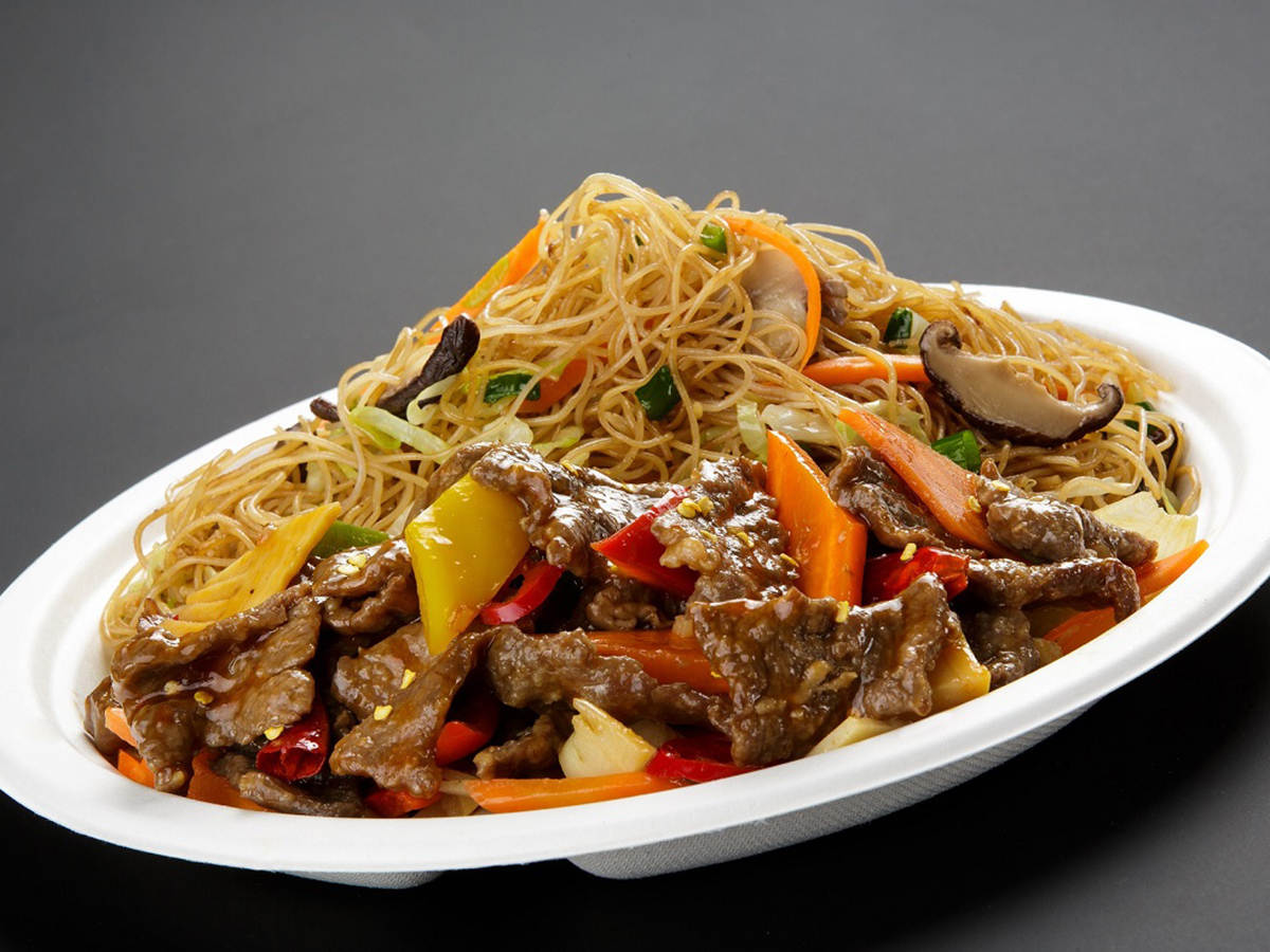 Beef stir fry with vegetable noodles served in a white oval takeout container at Dragon Inn, a Chinese Restaurant in Fredericksburg