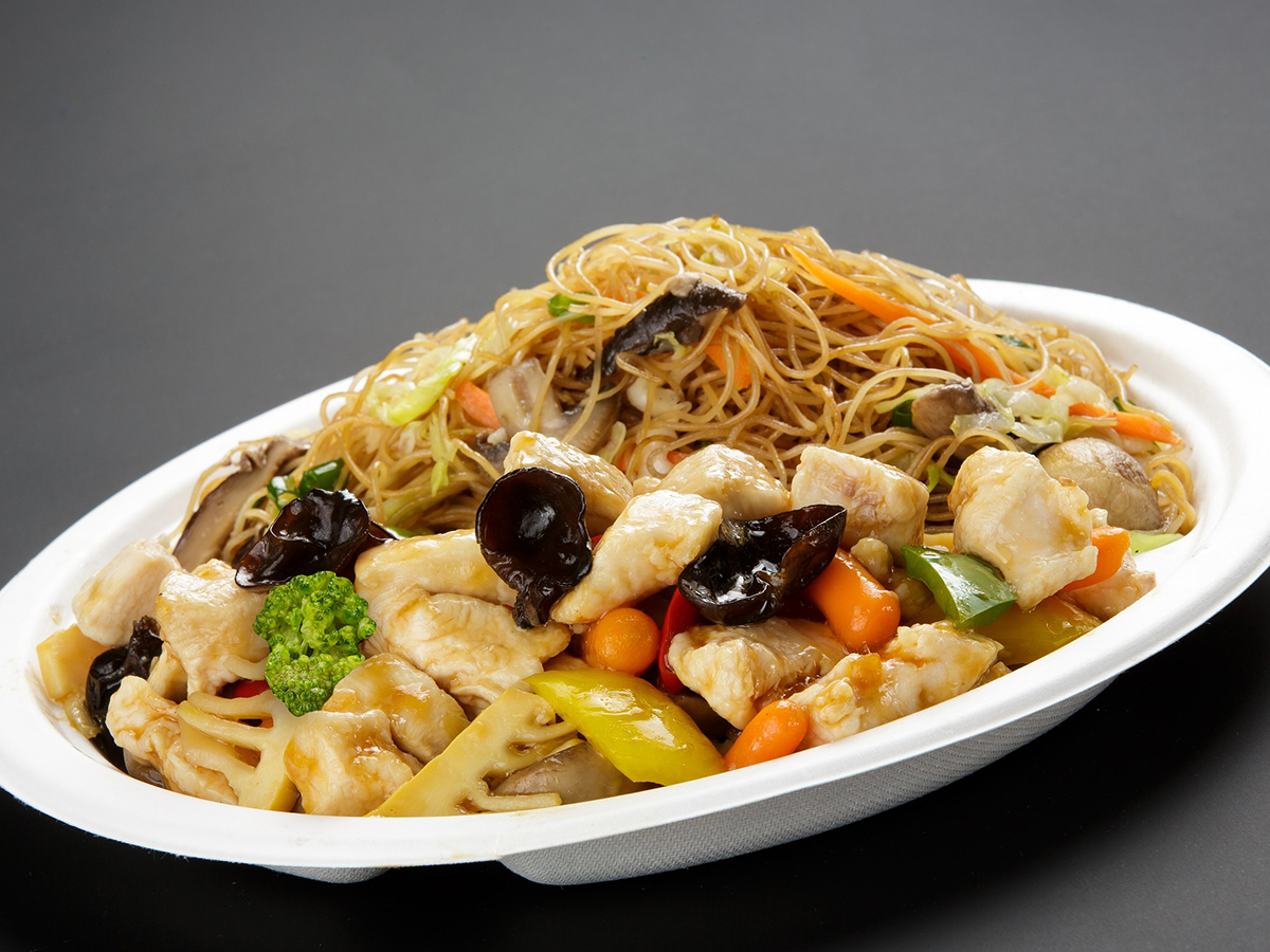 Diced chicken stir fry mixed with mushrooms, veggies and thin noodles on a white plate at Dragon Inn, a Chinese Restaurant in Fredericksburg