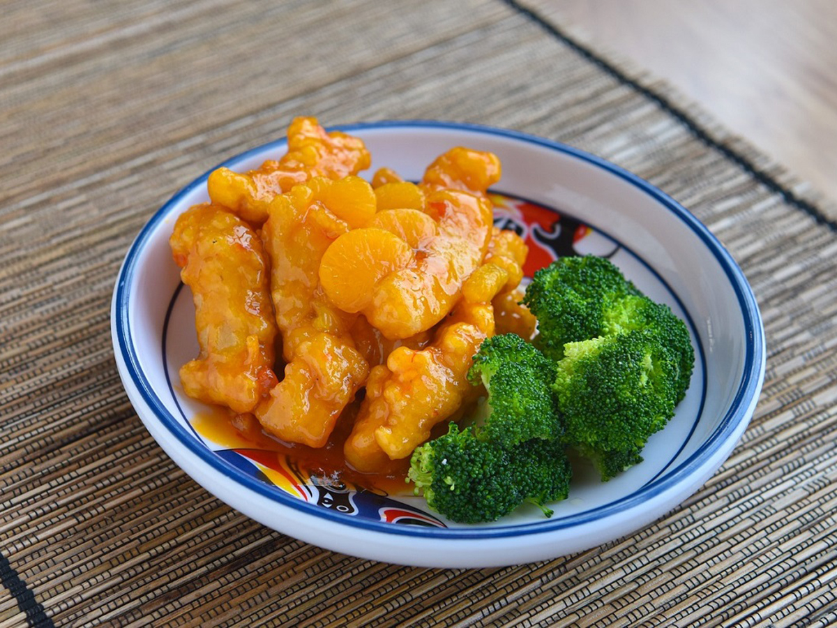 Crispy orange fish fillets served with fresh broccoli on decorated ceramic plate at Dragon Inn, a Chinese Restaurant in Fredericksburg