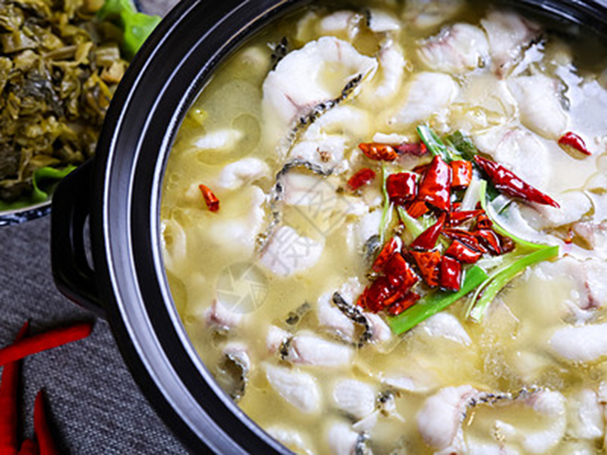 Hot pot of sour cabbage fish topped with dried chili peppers and green onions at Dragon Inn, a Chinese Restaurant in Fredericksburg