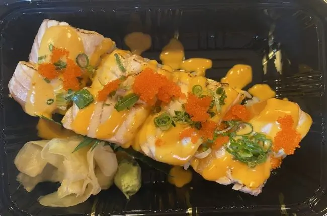 Grilled salmon sushi with mango sauce and tobiko at Dragon Sushi, a Japanese Restaurant in New York