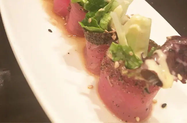 Seared tuna rolls with greens and creamy sauce at Dragon Sushi, a Japanese Restaurant in New York