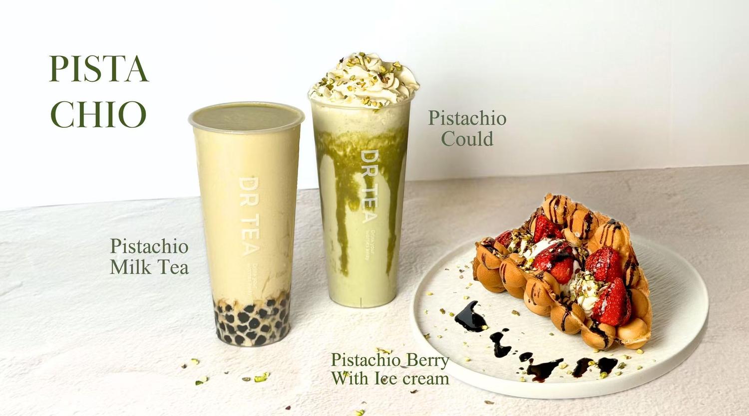 Two pistachio drinks with boba and whipped cream next to a strawberry ice cream bubble waffle on a white plate at Dr Tea, a Bubble tea store in Pittsburgh