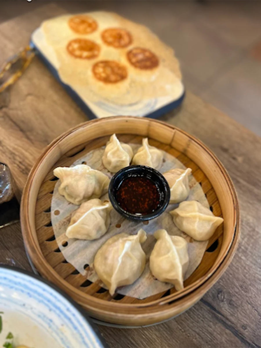 Dumplings in a steamer, with sauce beside them at Southside Dumpling Haus, a Chinese Restaurant in Corpus Christi