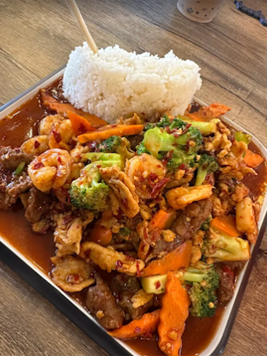 rice is served with a dish cooked with ingredients like shrimp, beef, chicken, broccoli, and carrots. The sauce is rich at Southside Dumpling Haus, a Chinese Restaurant in Corpus Christi