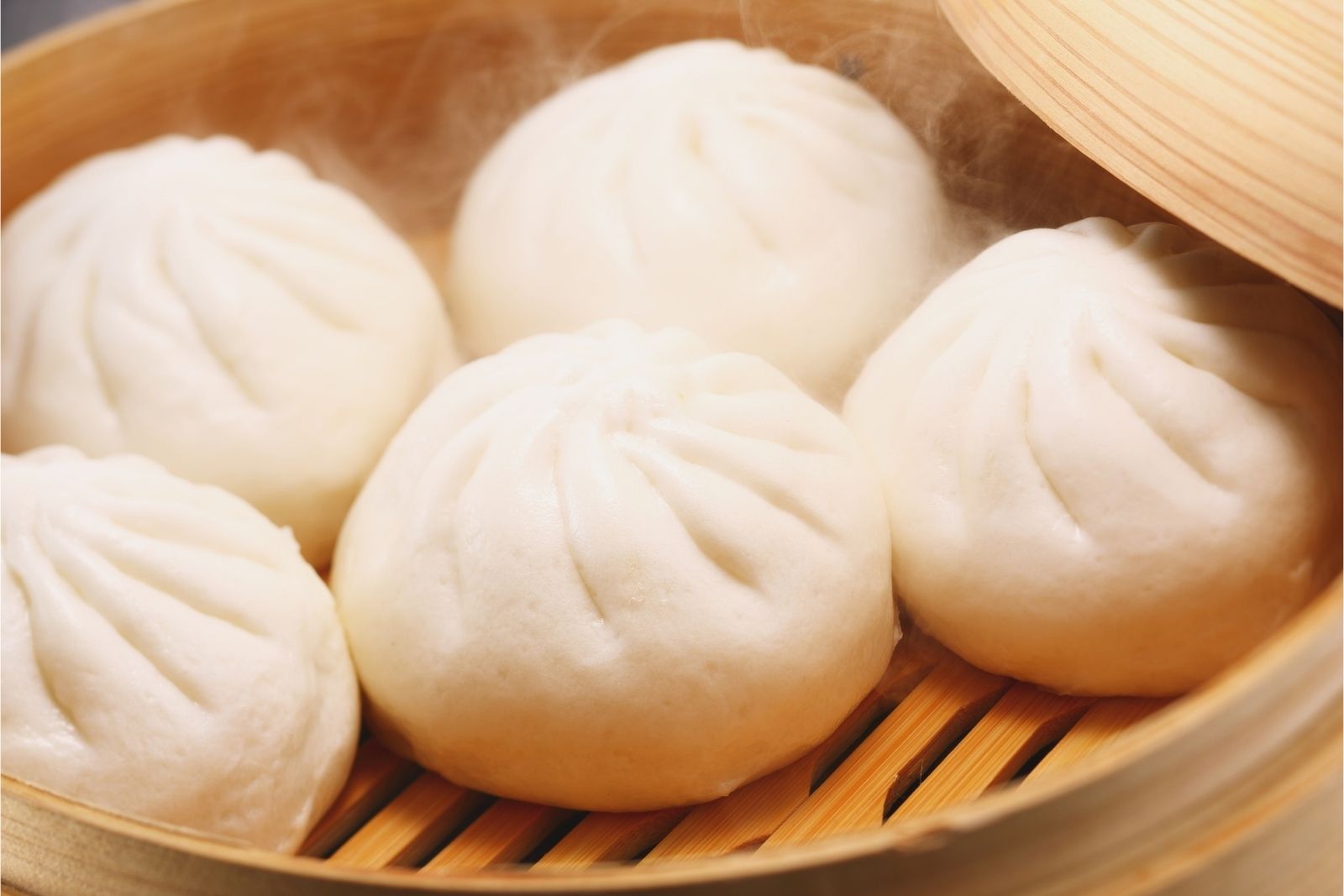 Steamed pork buns in bamboo steamer at Dumpling Bay, a Chinese Restaurant in Golden