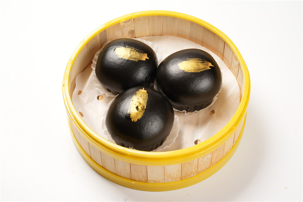 Black gold buns with golden brushstrokes at Dumpling Delight, a Chinese Restaurant in Millbrae