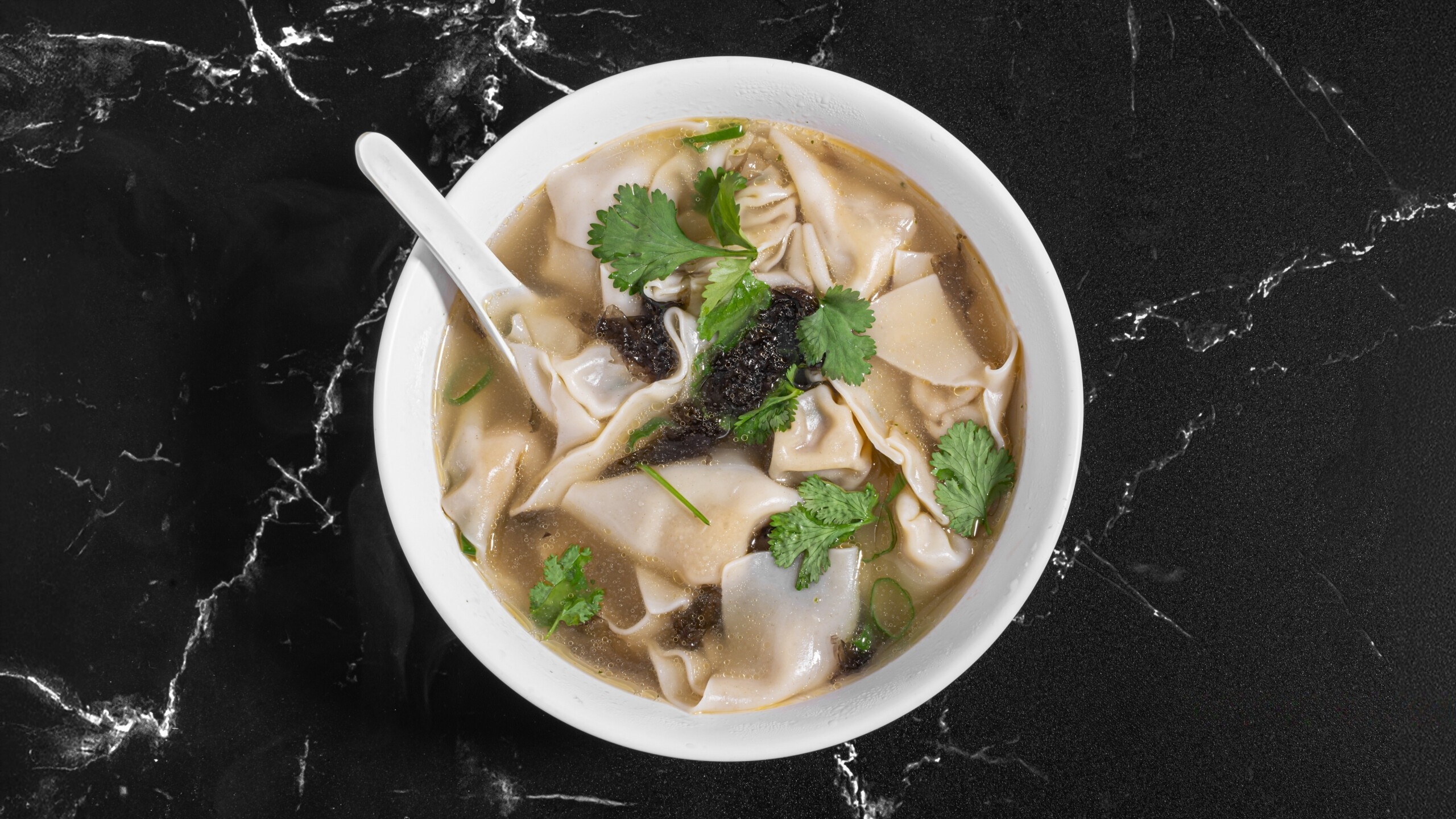 Dumpling-House-Dumpling-Restaurant-dumpling-soup-Alameda Soup with dumplings, cilantro, and seaweed at Dumpling House, a Dumpling Restaurant in Alameda