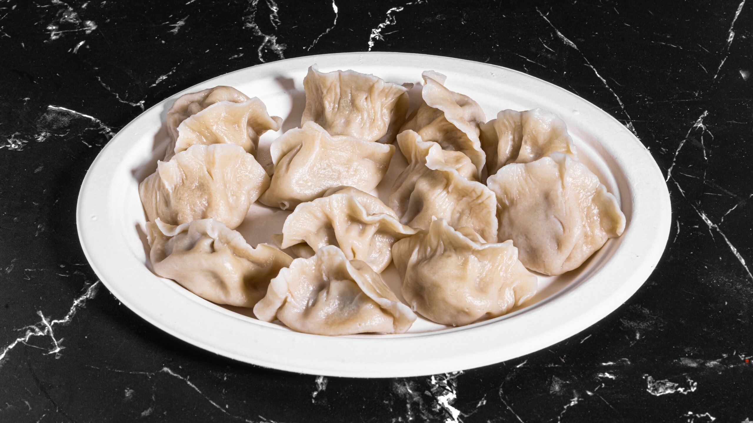 Dumpling-House-Dumpling-Restaurant-napa-cabbage-with-pork-dumpling-Alameda Napa cabbage and pork dumplings on a plate at Dumpling House, a Dumpling Restaurant in Alameda