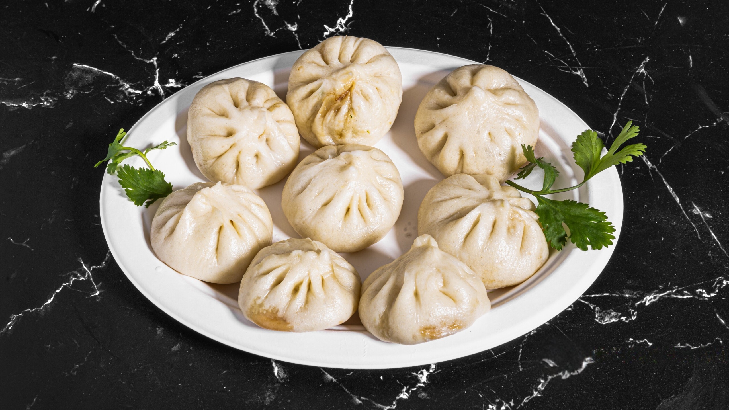 Dumpling-House-Dumpling-Restaurant-tiny-buns-Alameda Small steamed buns garnished with cilantro at Dumpling House, a Dumpling Restaurant in Alameda