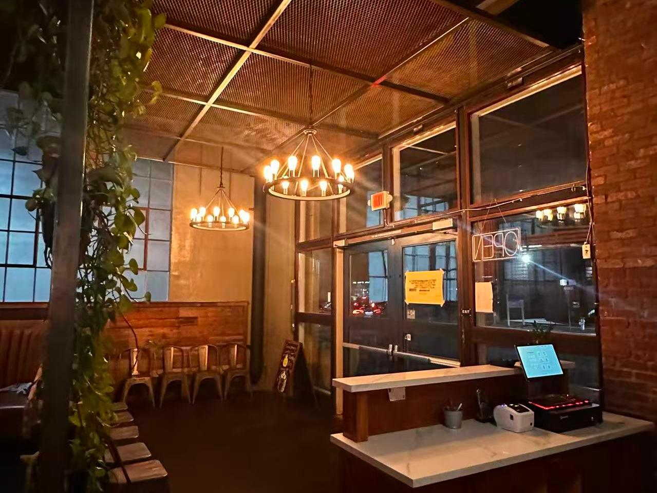 Inviting entrance area with chandeliers and a host stand at Dumpling King Asian Cuisine in Sacramento