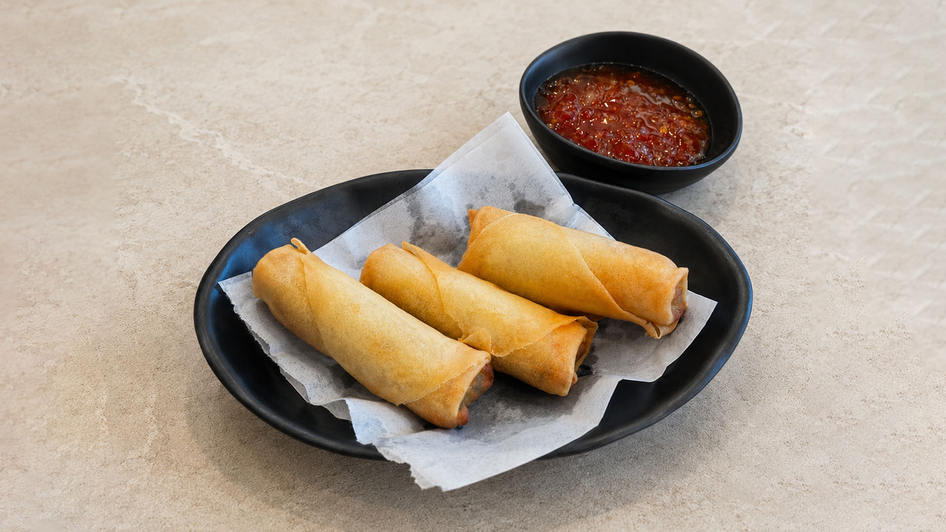 Three crispy spring rolls served with sweet chili dipping sauce