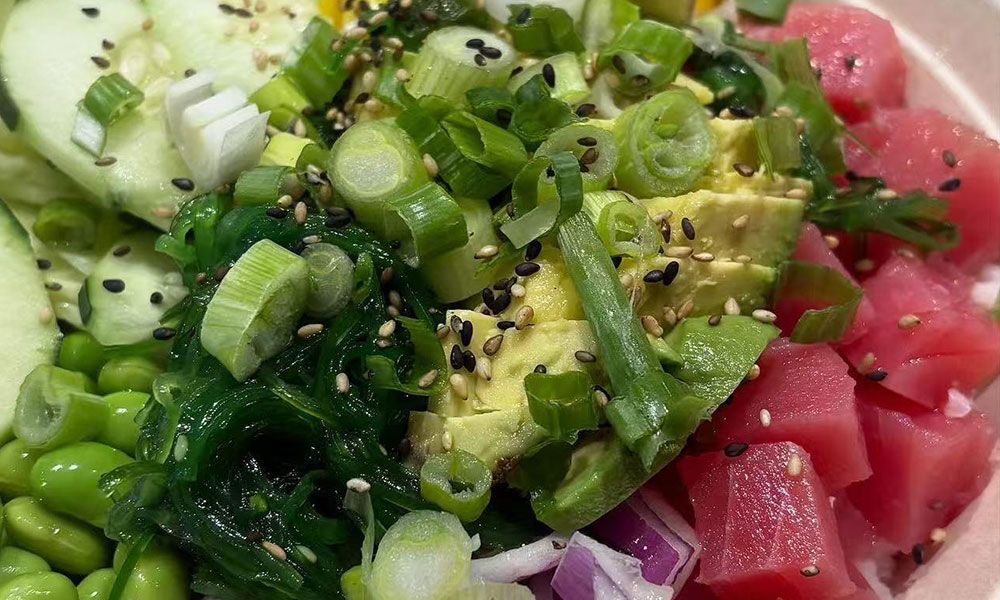 Close-up fresh tuna poke salad with avocado, edamame, seaweed, cucumber, green onion and toasted sesame seeds at Dumplings & Tea, a Asian Restaurant in Chesterfield