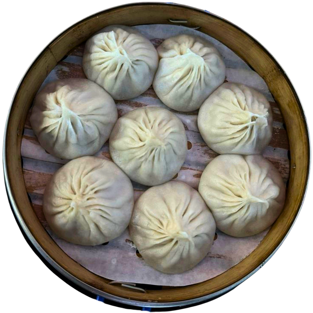 Steamed soup dumplings in a bamboo basket at Dumpling U, a Chinese Restaurant in Fresno