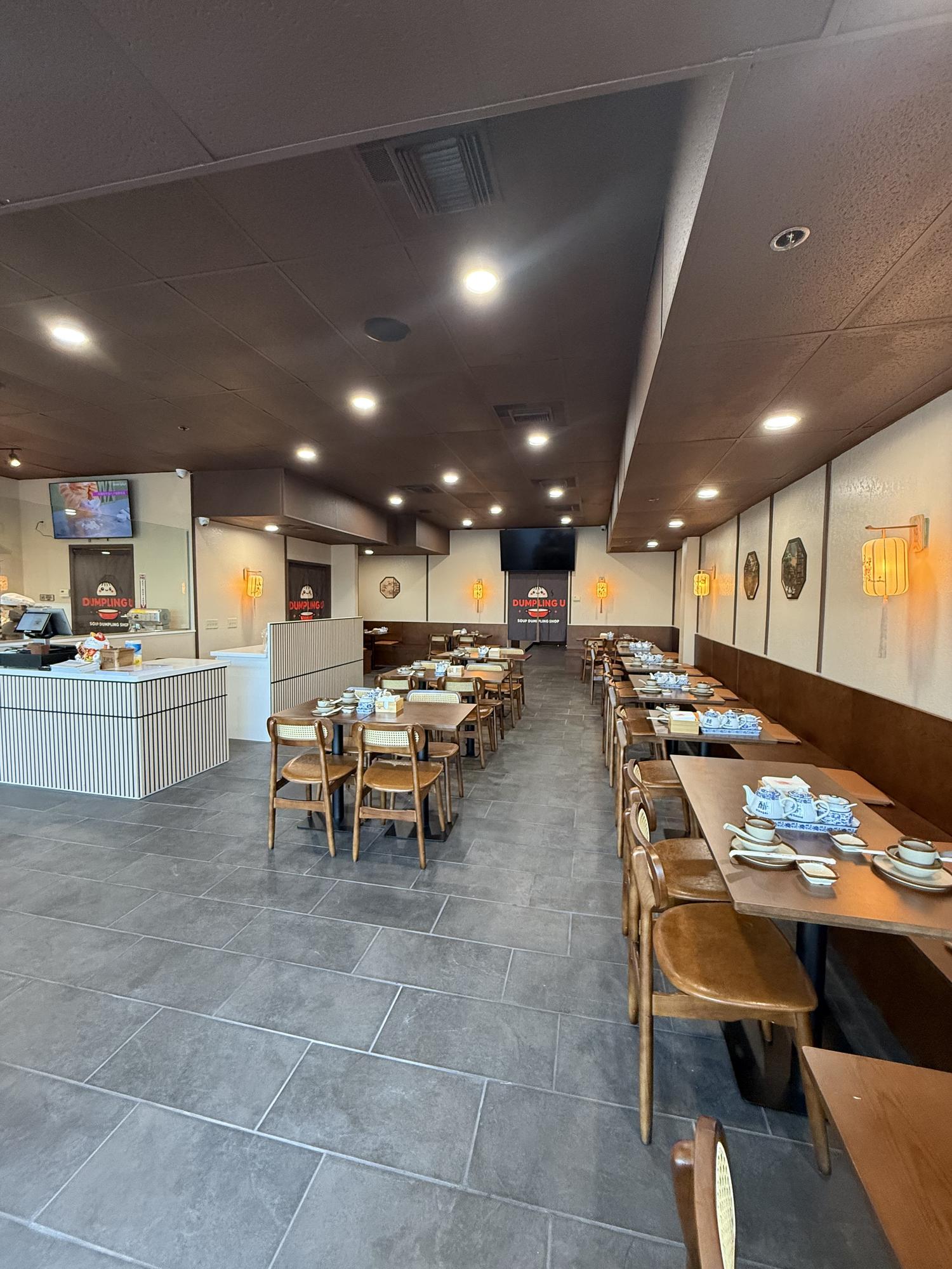 Dining space with windows and table settings at Dumpling U, a Chinese Restaurant in Fresno