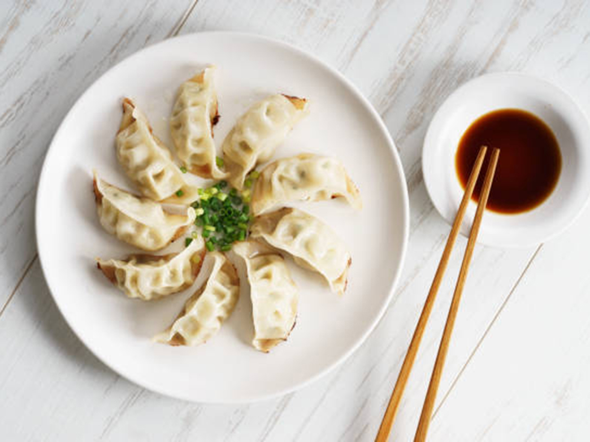 Potstickers with meat filling served with soy sauce at Dumpling Zone, a Chinese restaurant in San Francisco