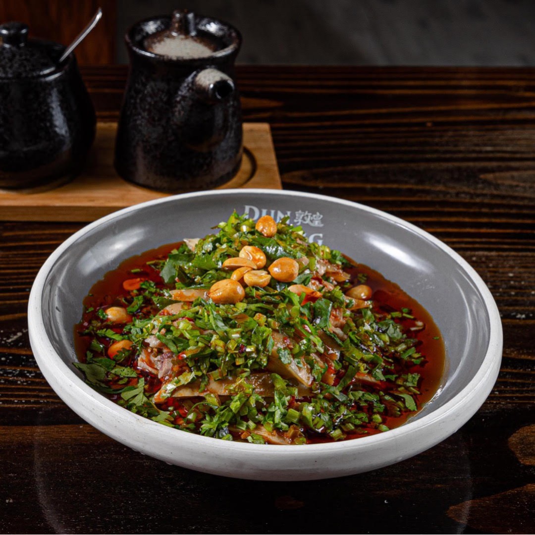 Spicy cold beef offal salad topped with peanuts and herbs at Dun Huang, a Chinese Restaurant in Brooklyn