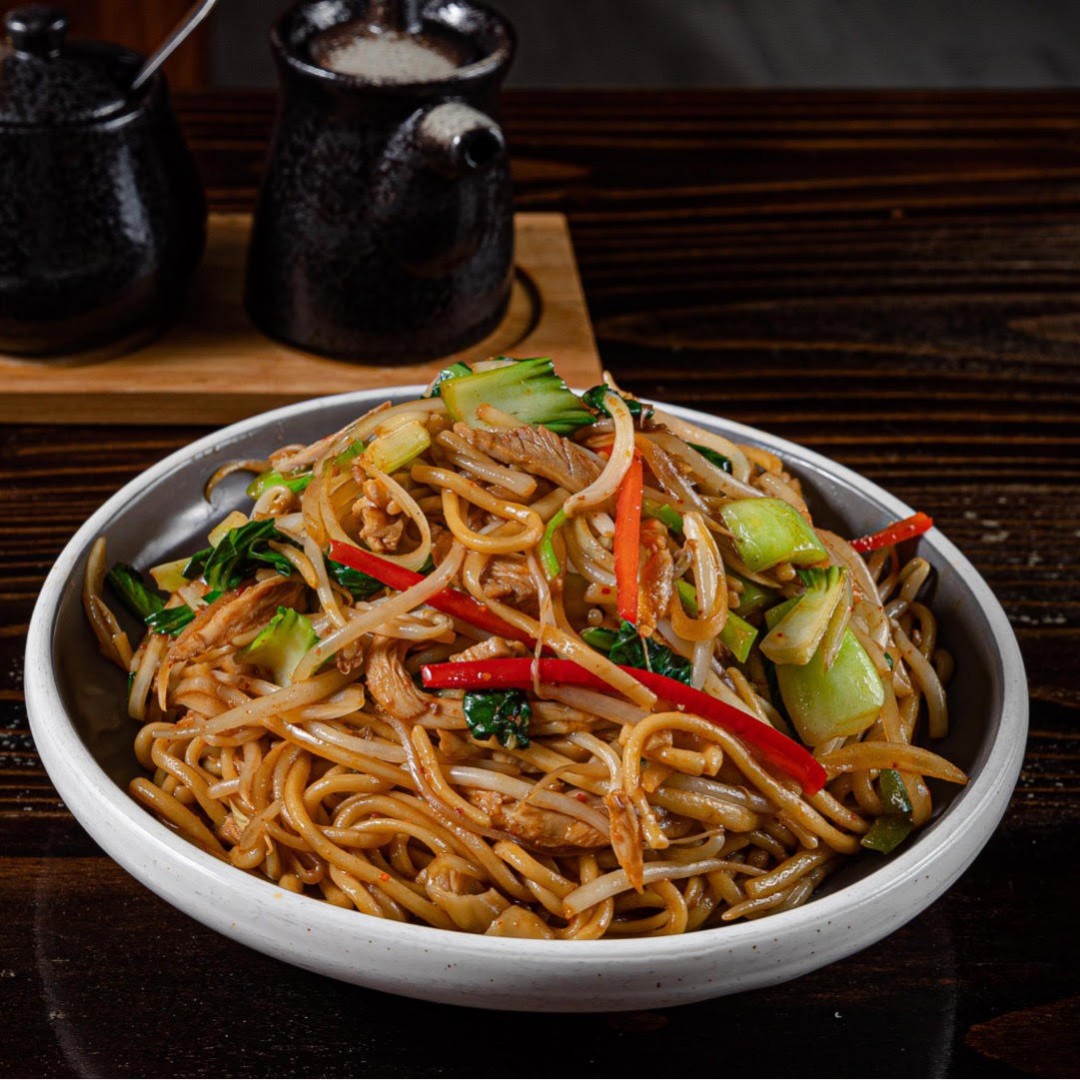 Savory stir‑fried noodles with fresh greens and shredded pork at Dun Huang, a Chinese Restaurant in Brooklyn